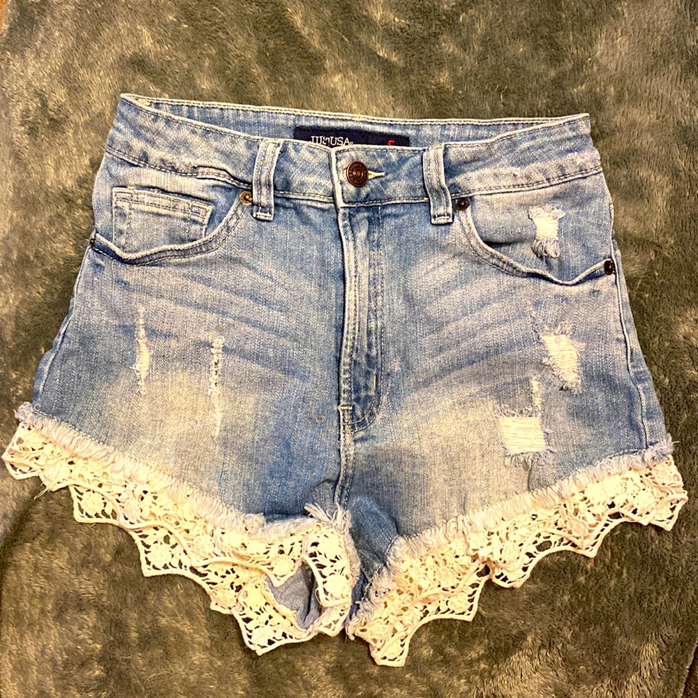Distressed Jean shorts with white lace seen on bottom